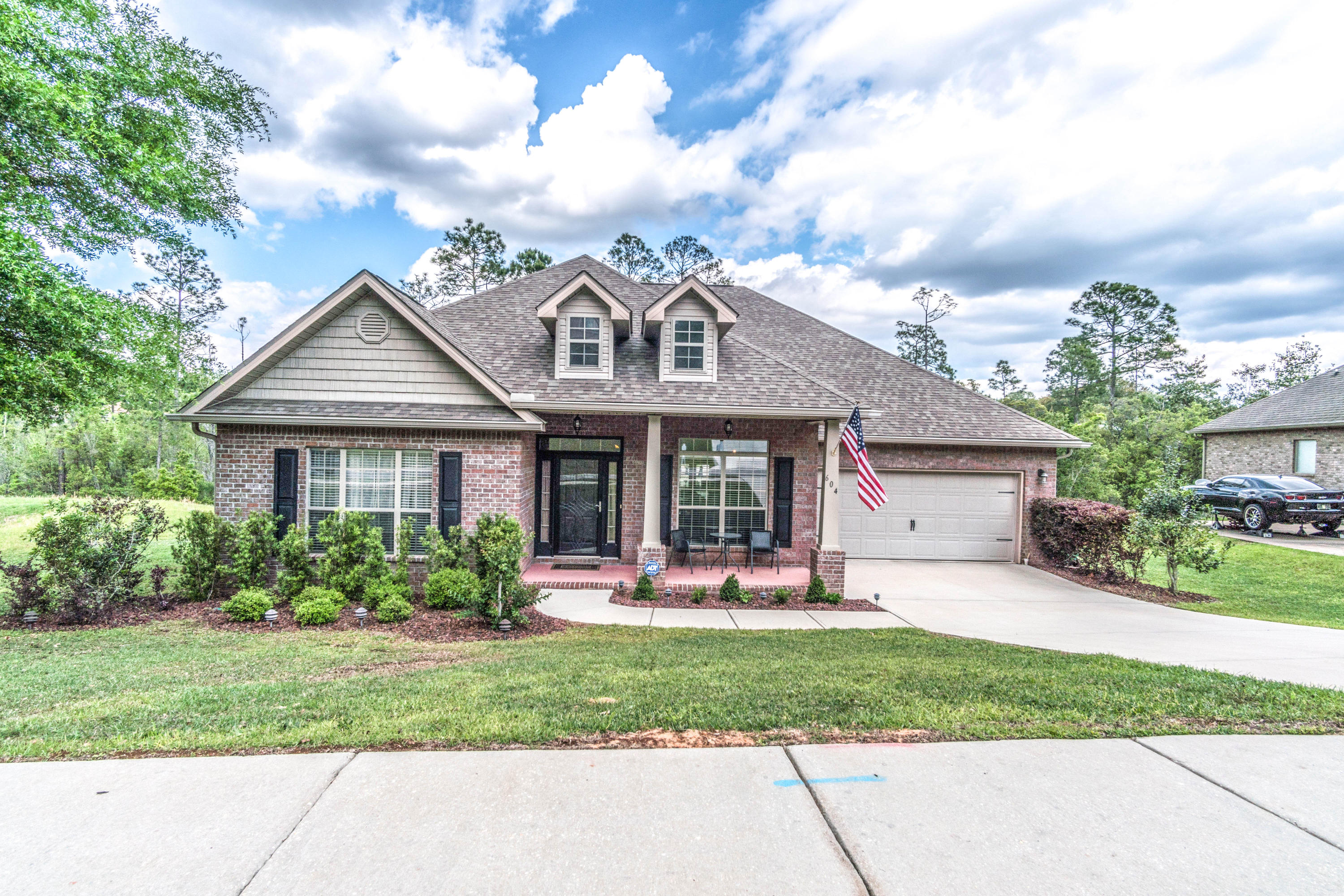 604 Red Fern Road Crestview, FL 32536 - Photo 36 of 36 a front view of a house with a garden and plants