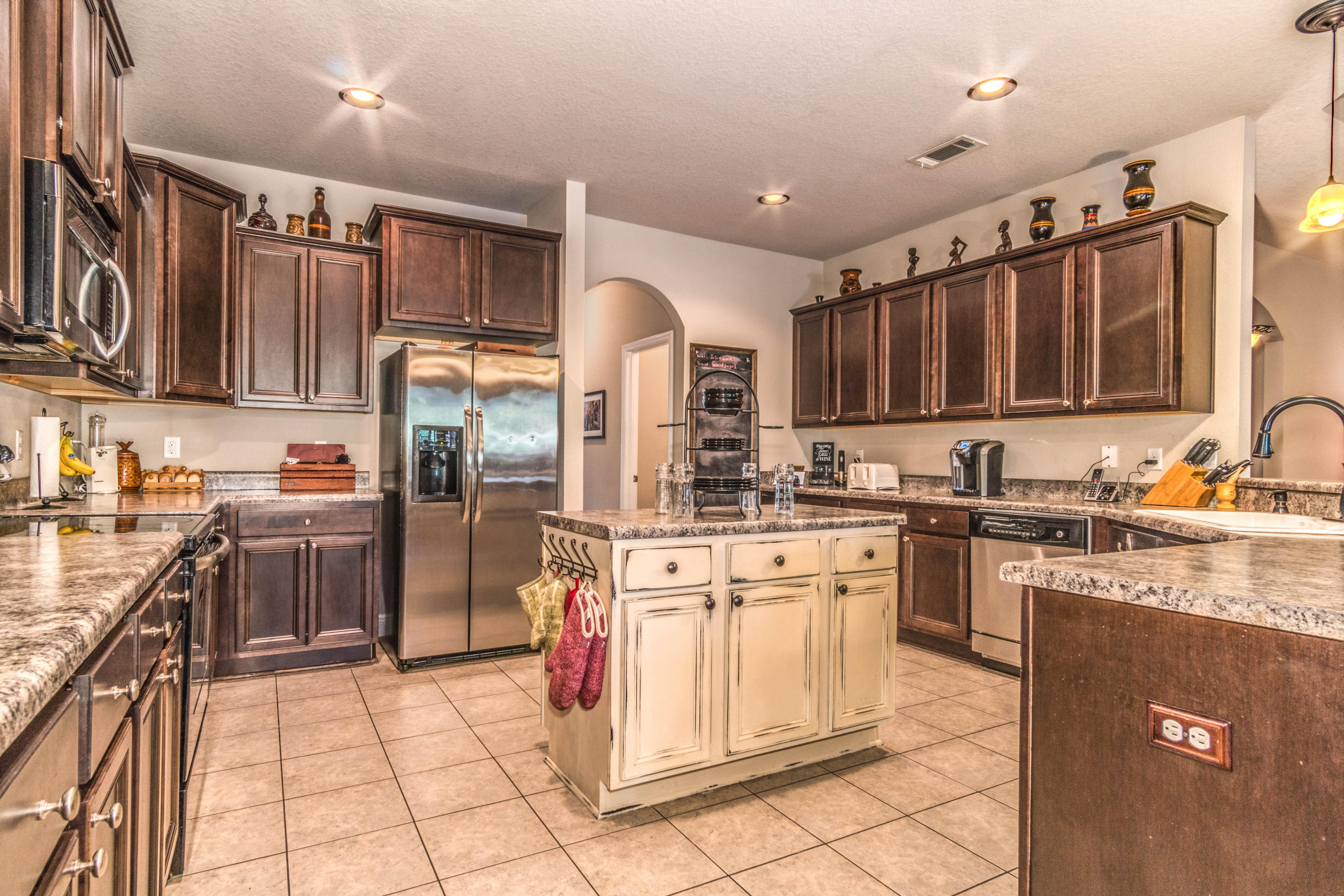 604 Red Fern Road Crestview, FL 32536 - Photo 6 of 36 a kitchen with stainless steel appliances granite countertop a refrigerator sink and cabinets