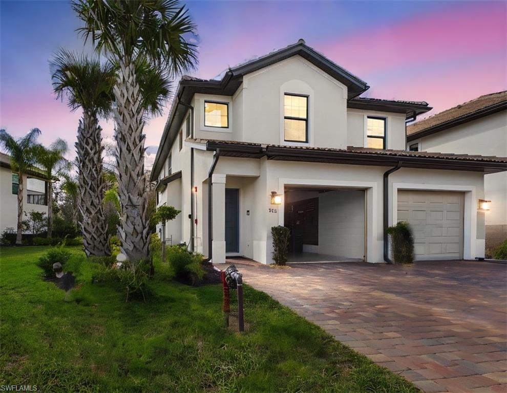 5683 Mayflower Way, Unit 908 Ave Maria, FL 34142 - Photo 37 of 37 View of front facade with decorative driveway, a front yard, stucco siding, and a tile roof