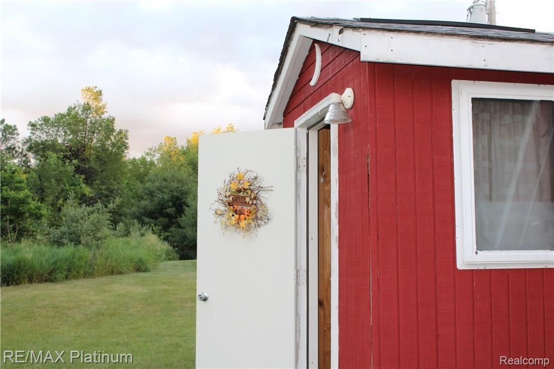 6691 Mabley Hill Road Fenton, MI 48430 - Photo 26 of 28 The crescent moon above the door says it all!