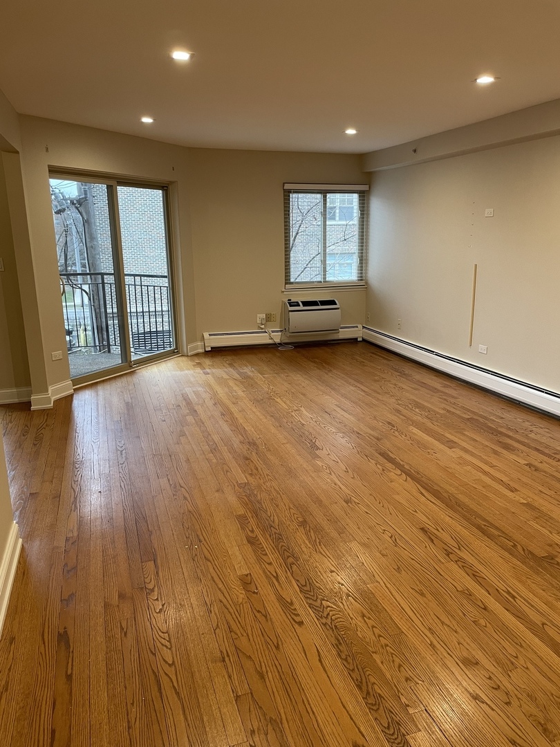 1 North Chestnut Avenue, Unit 2D Arlington Heights, IL 60005 - Photo 6 of 14 an empty room with wooden floor and windows