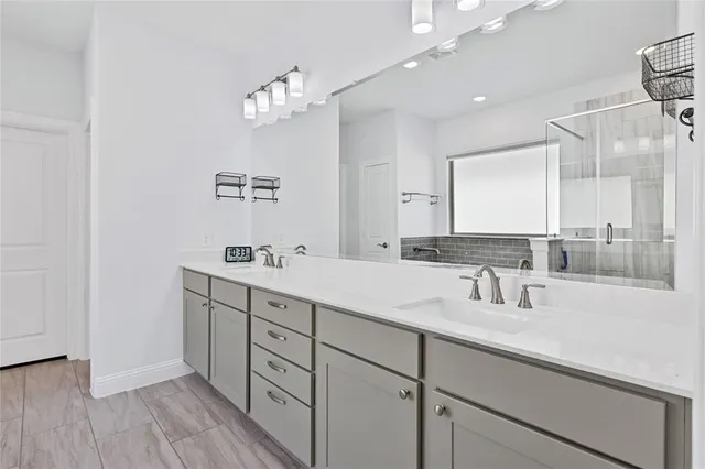 a bathroom with a sink double vanity and a mirror