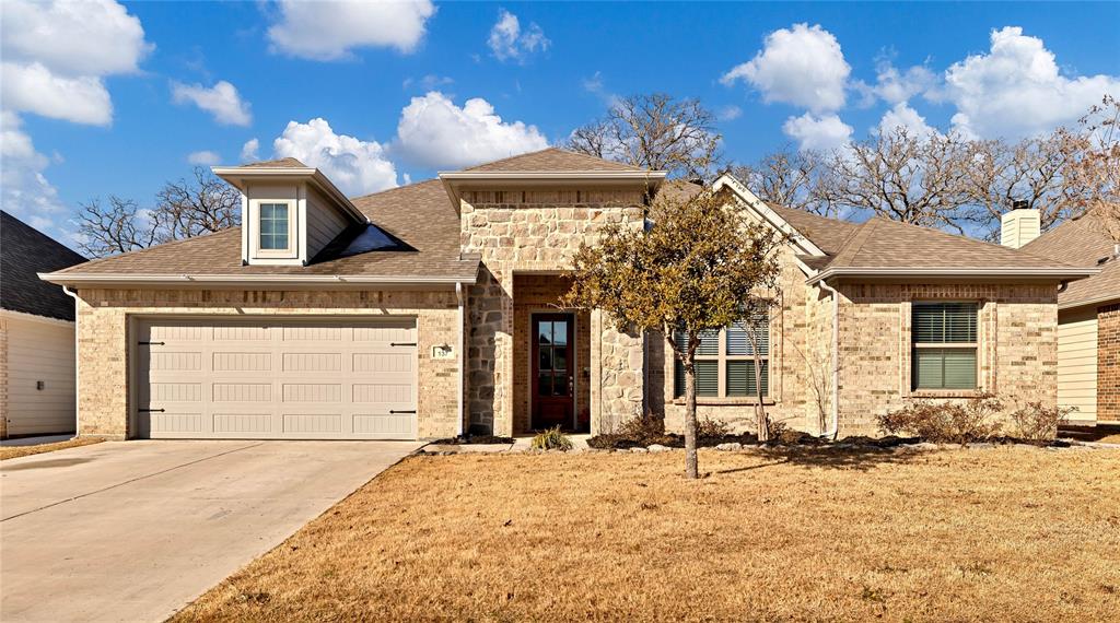 137 Gardenia Drive Azle, TX 76020 - Photo 27 of 38 View of front of house with a shingled roof, concrete driveway, and brick siding