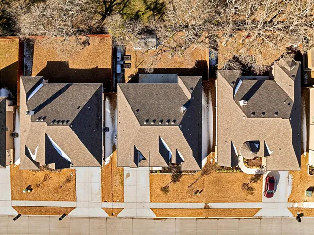 an aerial view of residential houses with city view