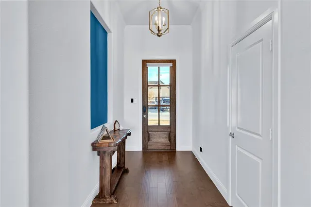 a view of hallway with wooden floor