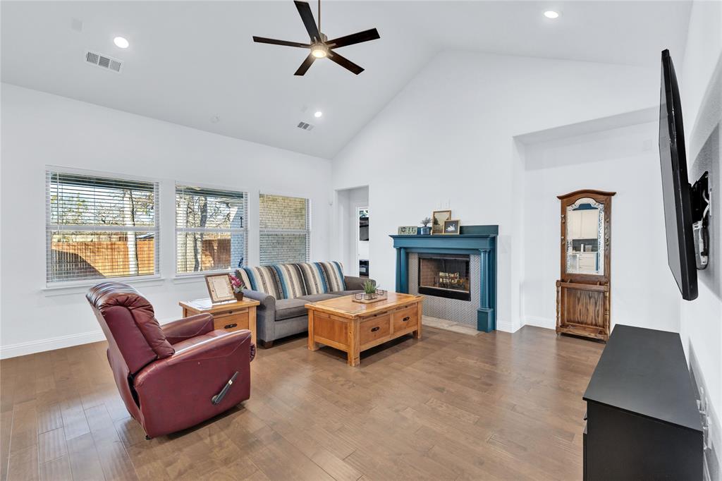 137 Gardenia Drive Azle, TX 76020 - Photo 6 of 38 Living area with wood finished floors, a ceiling fan, vaulted ceiling, recessed lighting, and a fireplace