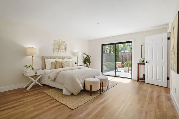 a bedroom with a bed and a night stand