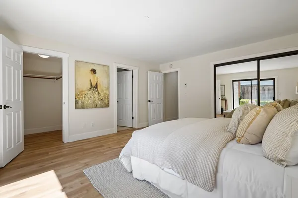 a bedroom with a bed and a mirror