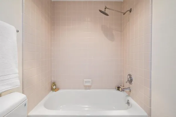 a bathroom with a white bath tub and a shower