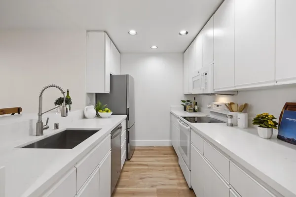 a kitchen with a sink and white cabinets