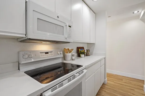 a kitchen with a sink stove and cabinets