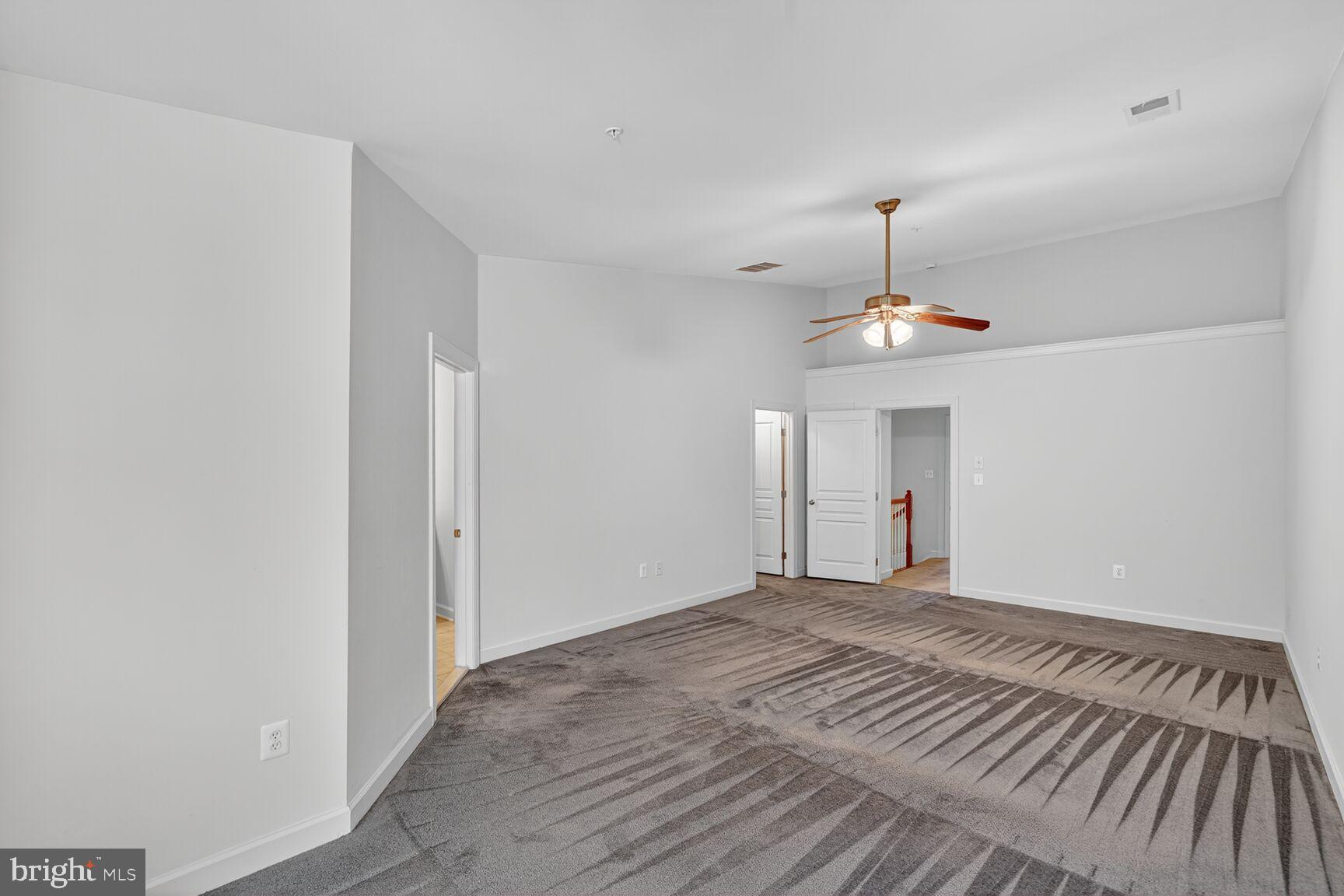 1755 Chiswick Court Silver Spring, MD 20904 - Photo 12 of 34 a view of an empty room with a chandelier fan