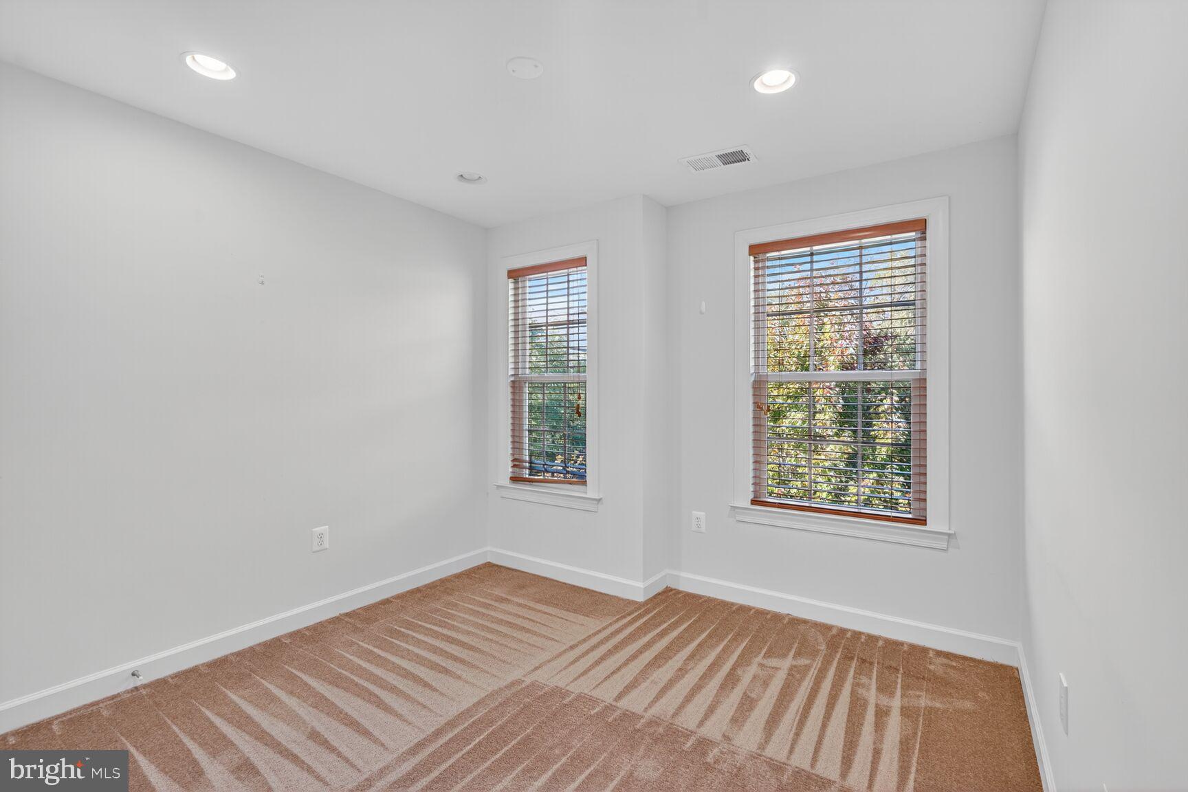 1755 Chiswick Court Silver Spring, MD 20904 - Photo 18 of 34 an empty room with wooden floor and windows