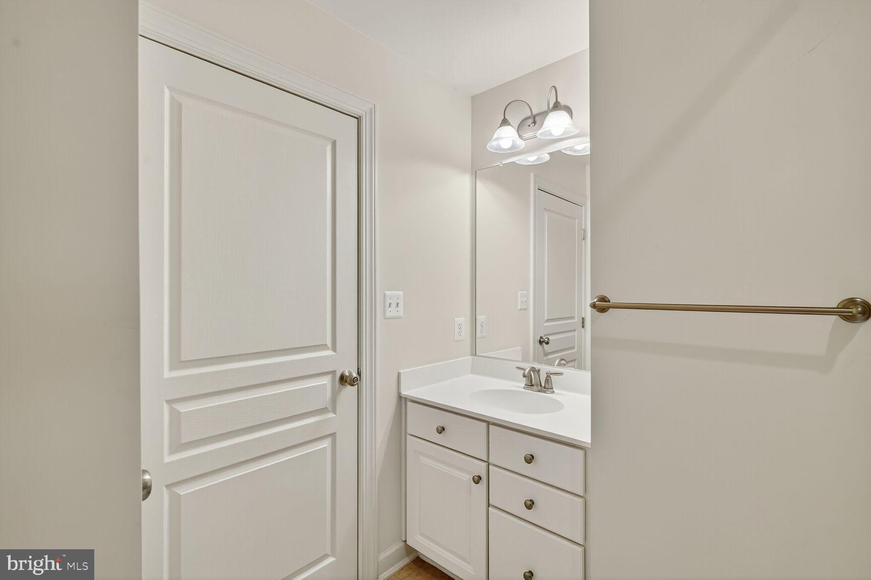1755 Chiswick Court Silver Spring, MD 20904 - Photo 21 of 34 a bathroom with a double vanity sink and a mirror