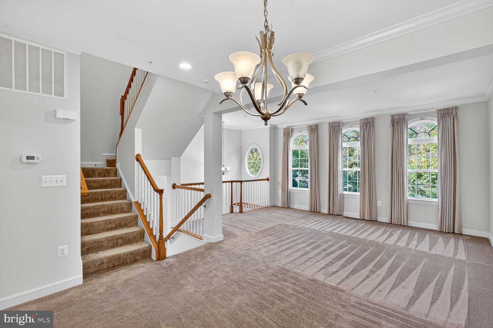 1755 Chiswick Court Silver Spring, MD 20904 - Photo 5 of 34 a view of a livingroom with wooden floor and stairs