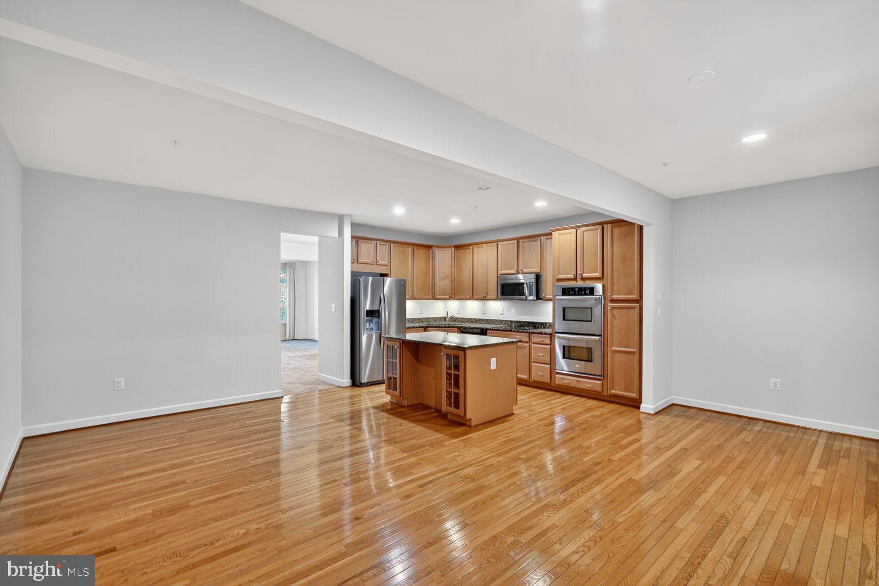 1755 Chiswick Court Silver Spring, MD 20904 - Photo 6 of 34 a large kitchen with stainless steel appliances granite countertop a large counter top and a stove