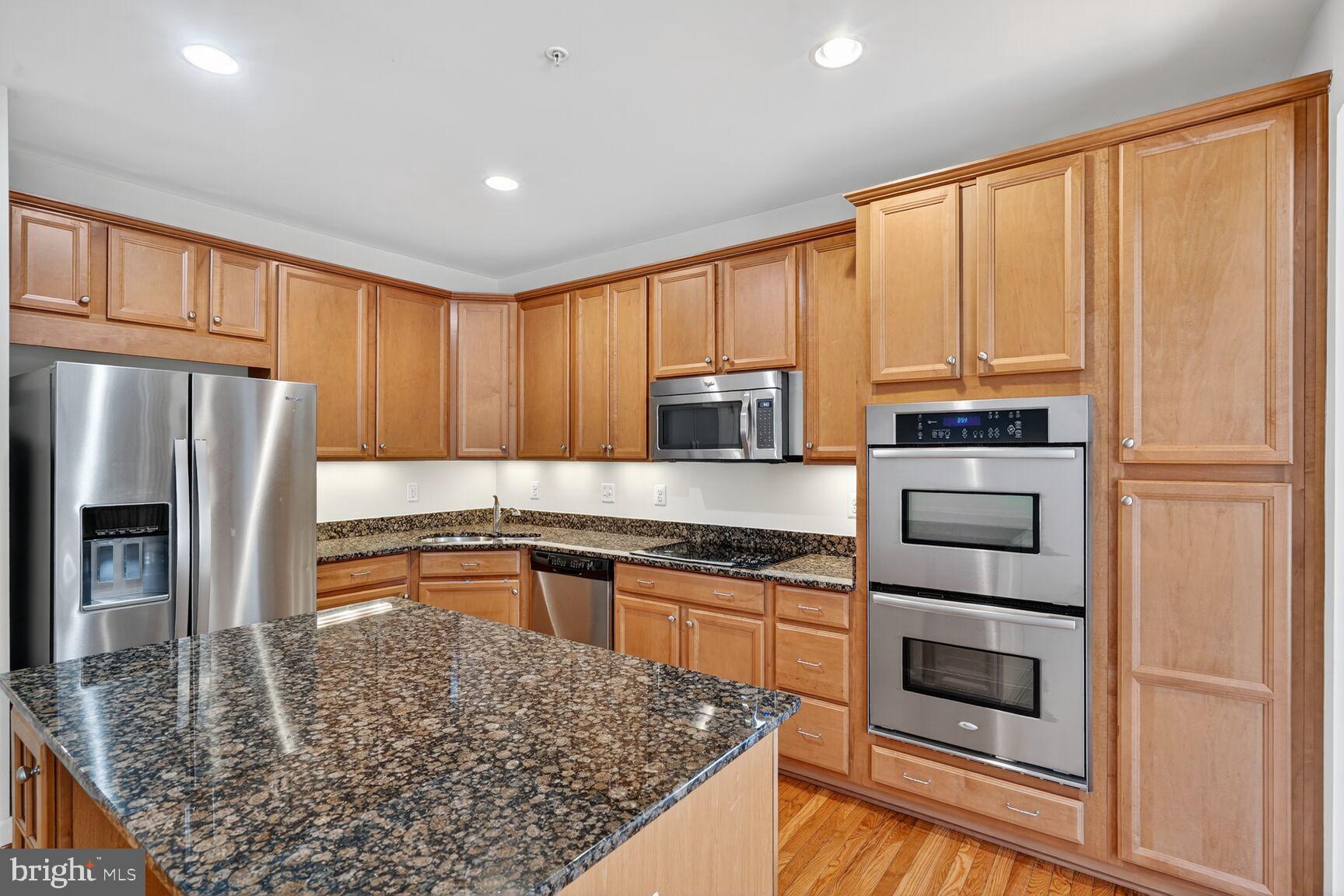 1755 Chiswick Court Silver Spring, MD 20904 - Photo 8 of 34 a kitchen with stainless steel appliances granite countertop a refrigerator sink and microwave