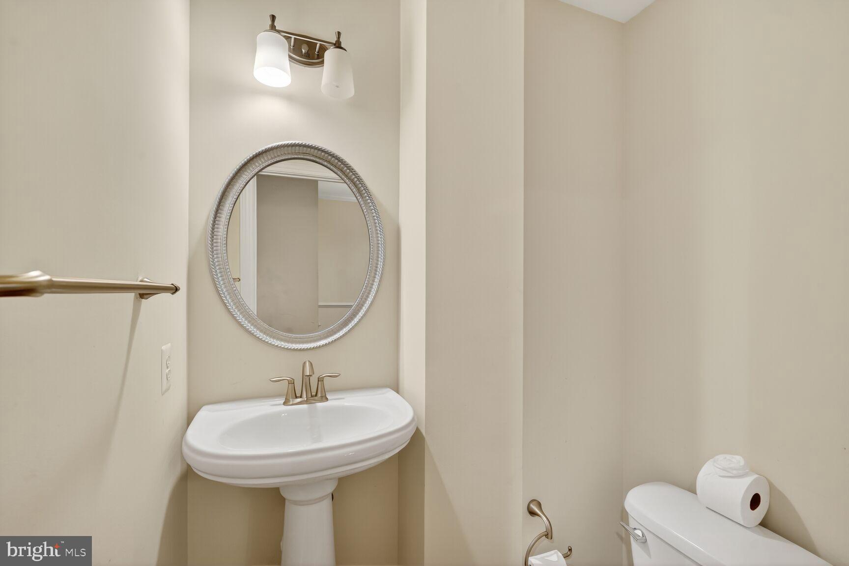 1755 Chiswick Court Silver Spring, MD 20904 - Photo 9 of 34 a bathroom with a sink a mirror and a toilet