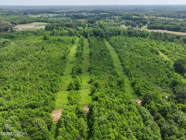 a view of a green field with an outdoor space