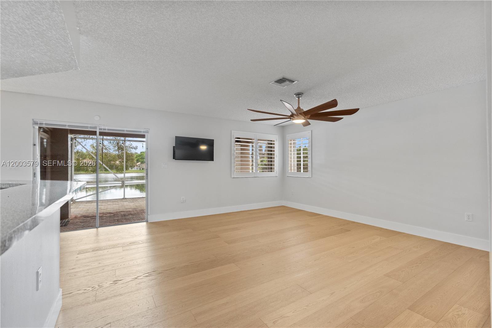 237 Northwest 100th Avenue Plantation, FL 33324 - Photo 17 of 86 an empty room with wooden floor and windows