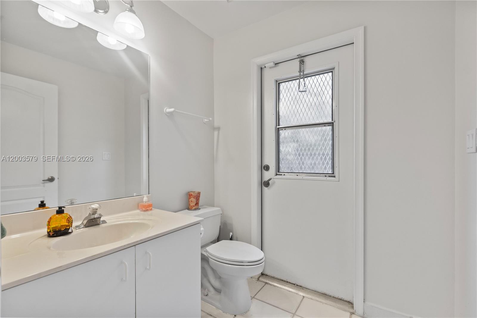 237 Northwest 100th Avenue Plantation, FL 33324 - Photo 29 of 86 a bathroom with a sink a toilet and mirror