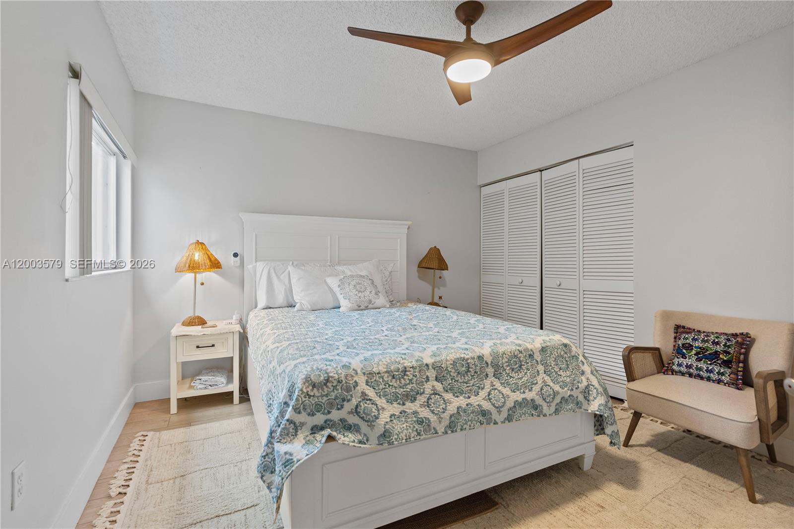 237 Northwest 100th Avenue Plantation, FL 33324 - Photo 39 of 86 a bedroom with a bed and a chandelier