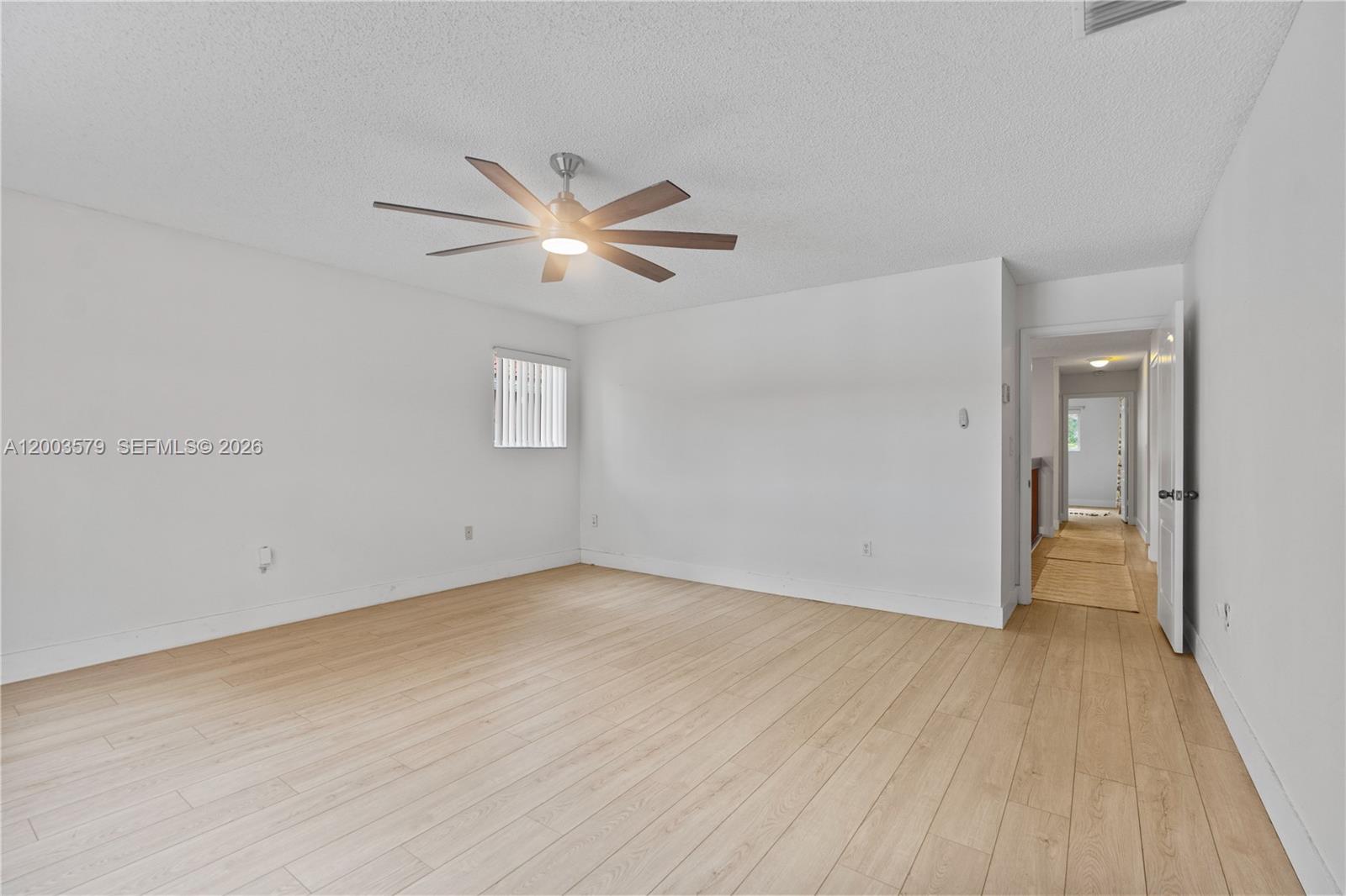 237 Northwest 100th Avenue Plantation, FL 33324 - Photo 47 of 86 an empty room with wooden floor and a ceiling fan
