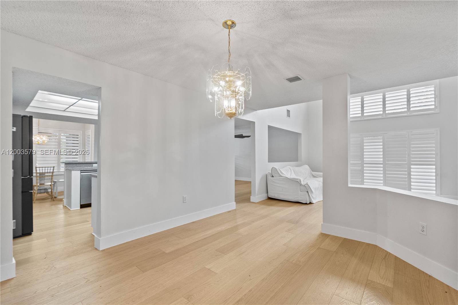 237 Northwest 100th Avenue Plantation, FL 33324 - Photo 5 of 86 a bedroom with furniture and a chandelier