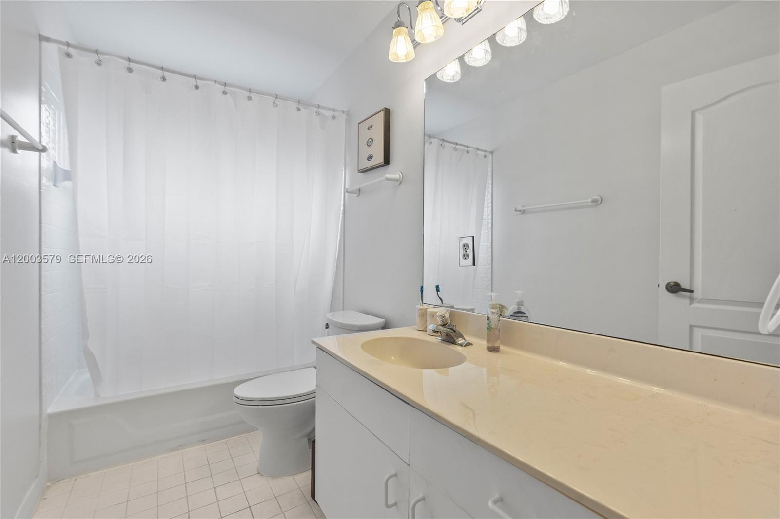 237 Northwest 100th Avenue Plantation, FL 33324 - Photo 55 of 86 a bathroom with a sink a toilet and a mirror