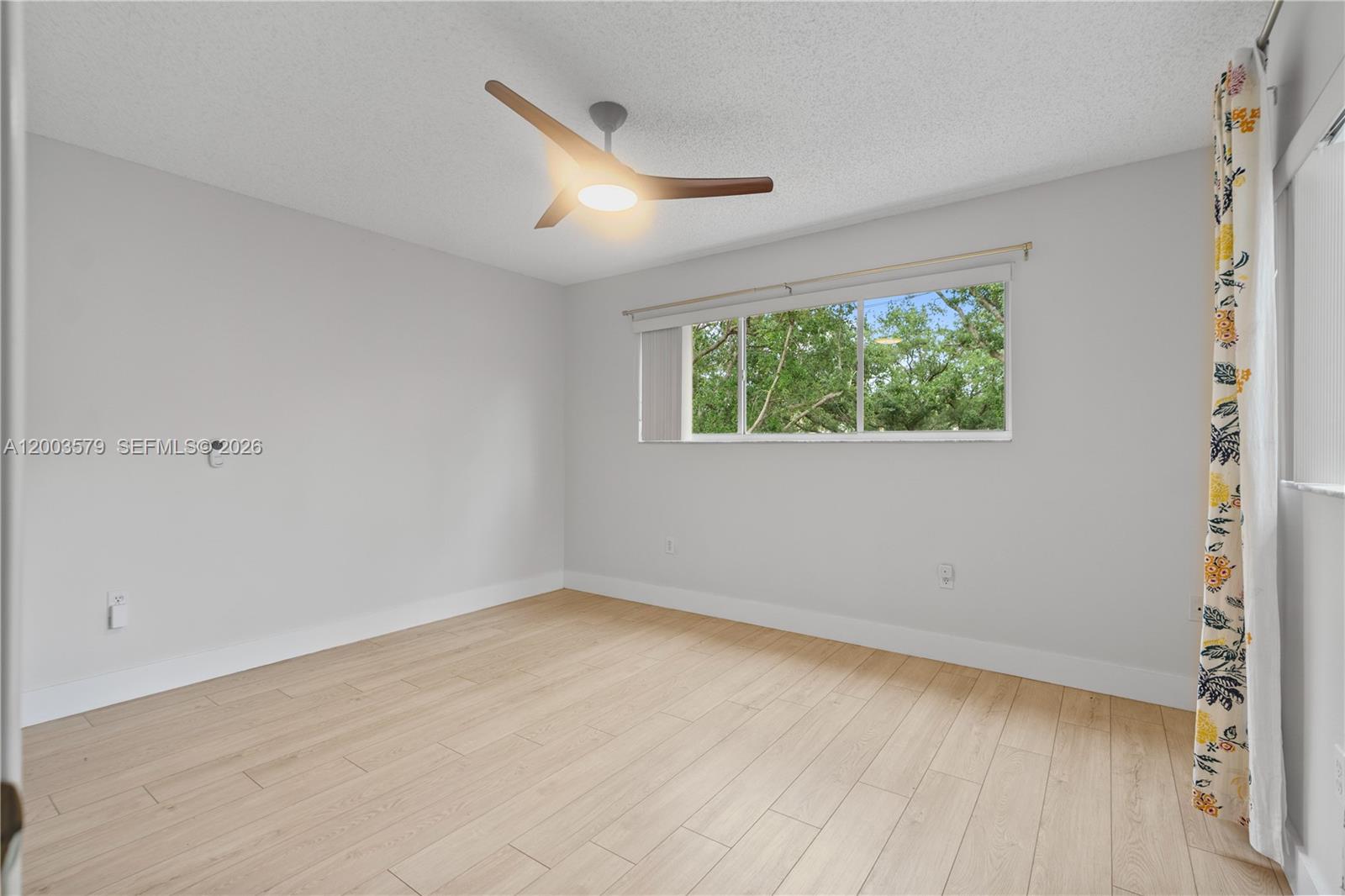 237 Northwest 100th Avenue Plantation, FL 33324 - Photo 56 of 86 an empty room with wooden floor and windows