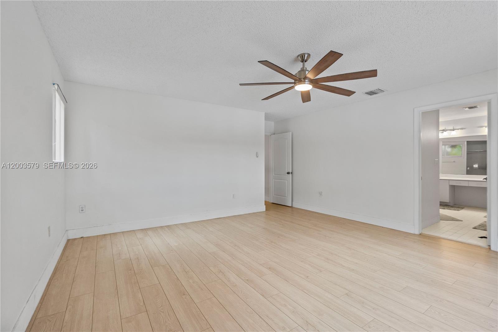 237 Northwest 100th Avenue Plantation, FL 33324 - Photo 60 of 86 an empty room with wooden floor and a ceiling fan