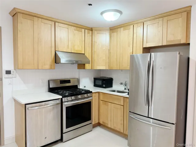 a kitchen with cabinets and stainless steel appliances