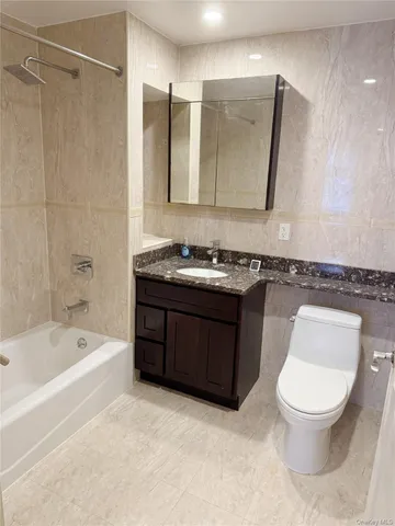 a bathroom with a toilet a sink and bathtub