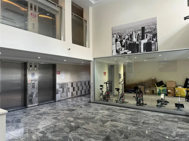 a view of a hallway with a large mirror on a dresser