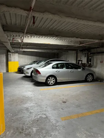 a view of parking garage with cars