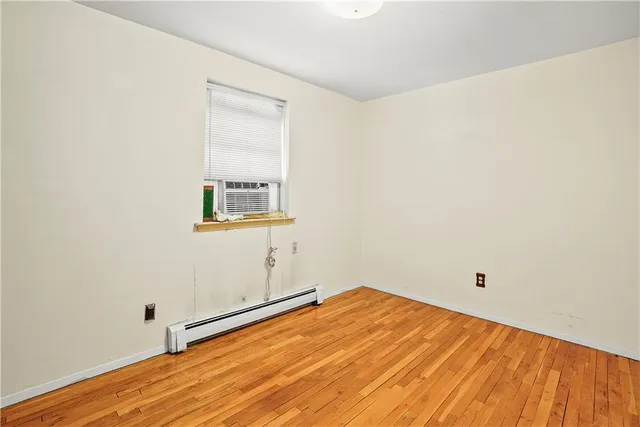 a view of a room with wooden floor and white walls
