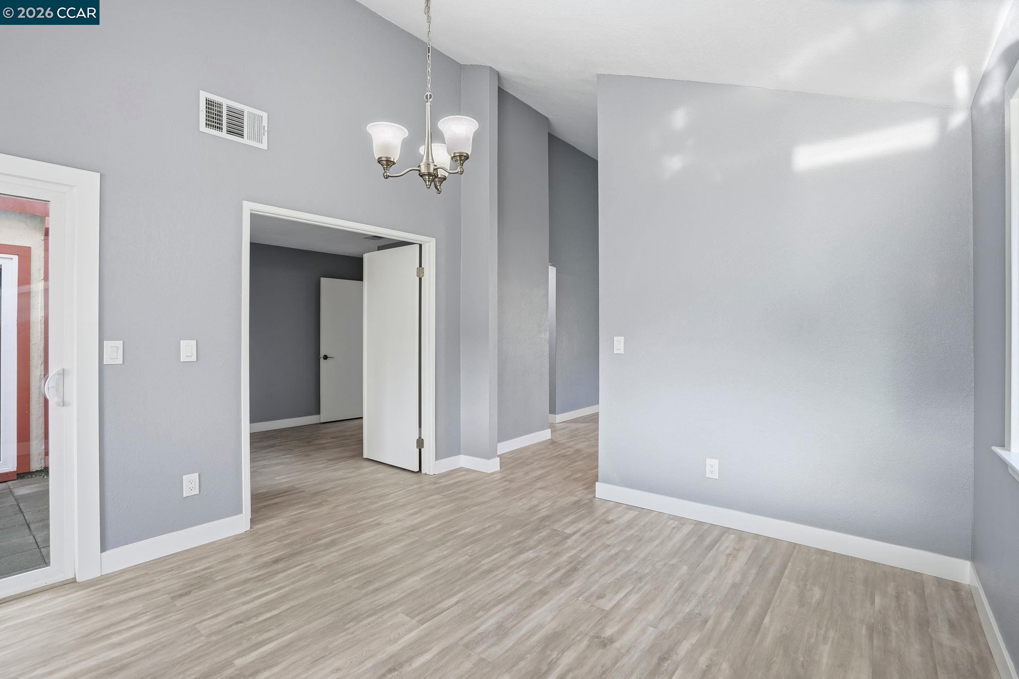 834 Coral Ridge Circle Rodeo, CA 94572 - Photo 11 of 32 wooden floor in an empty room with a mirror