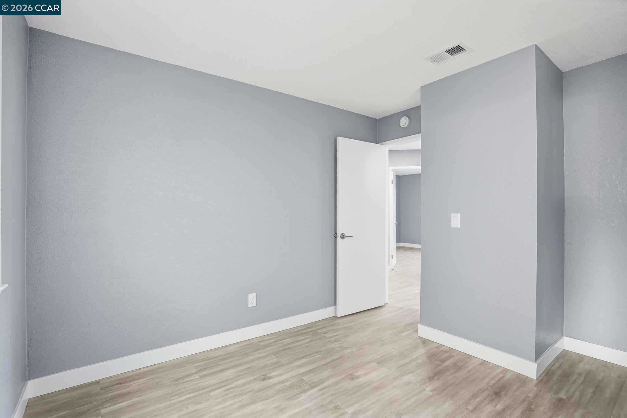 834 Coral Ridge Circle Rodeo, CA 94572 - Photo 15 of 32 a view of an empty room with wooden floor