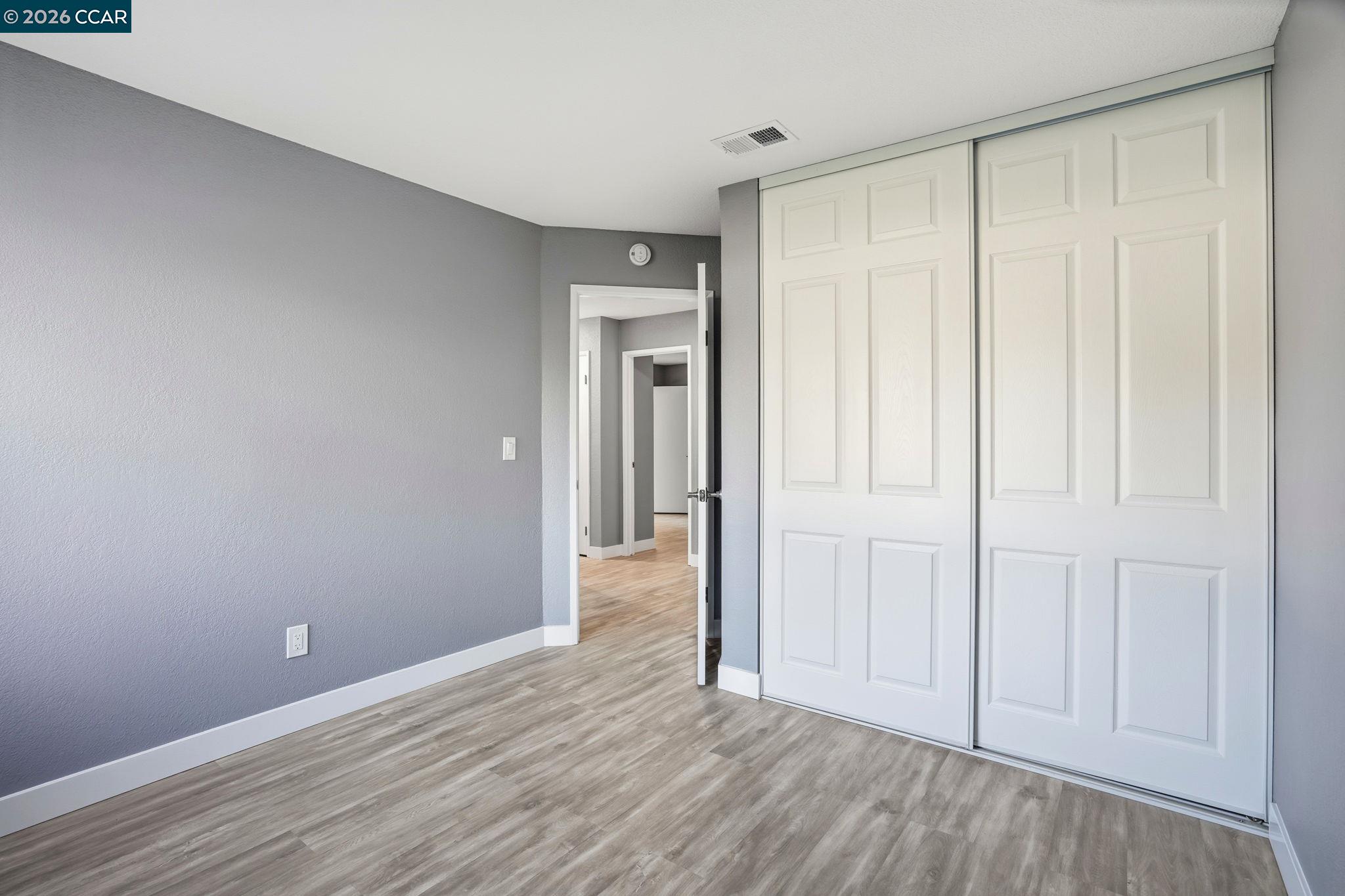 834 Coral Ridge Circle Rodeo, CA 94572 - Photo 20 of 32 a view of an empty room with closet and wooden floor