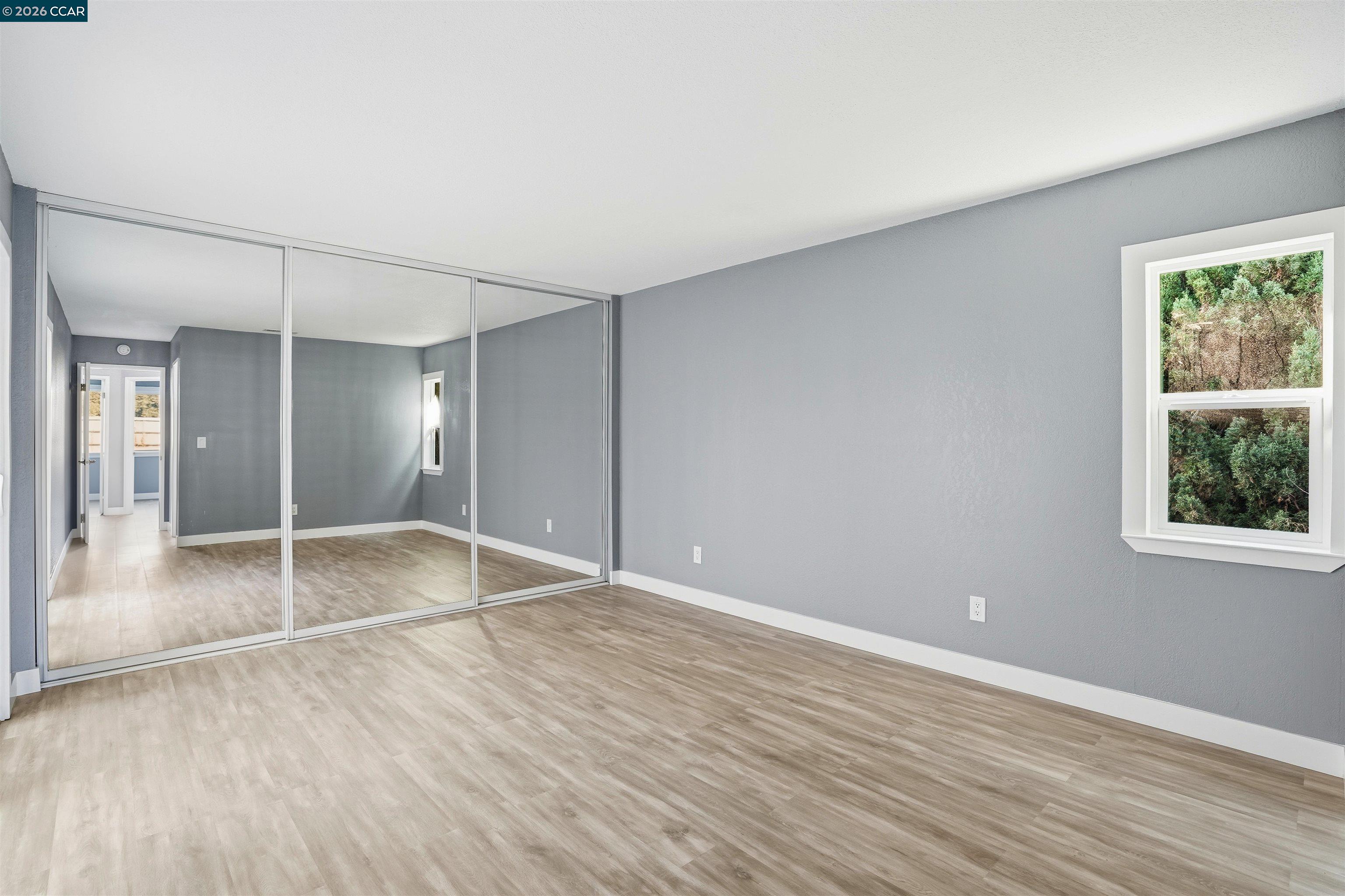 834 Coral Ridge Circle Rodeo, CA 94572 - Photo 25 of 32 wooden floor in an empty room with a window
