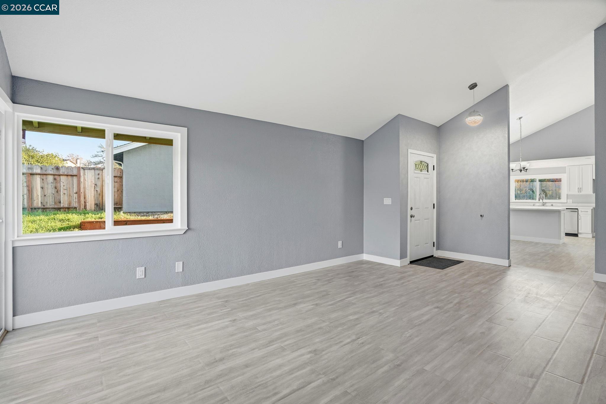 834 Coral Ridge Circle Rodeo, CA 94572 - Photo 3 of 32 a view of an empty room with wooden floor and a window