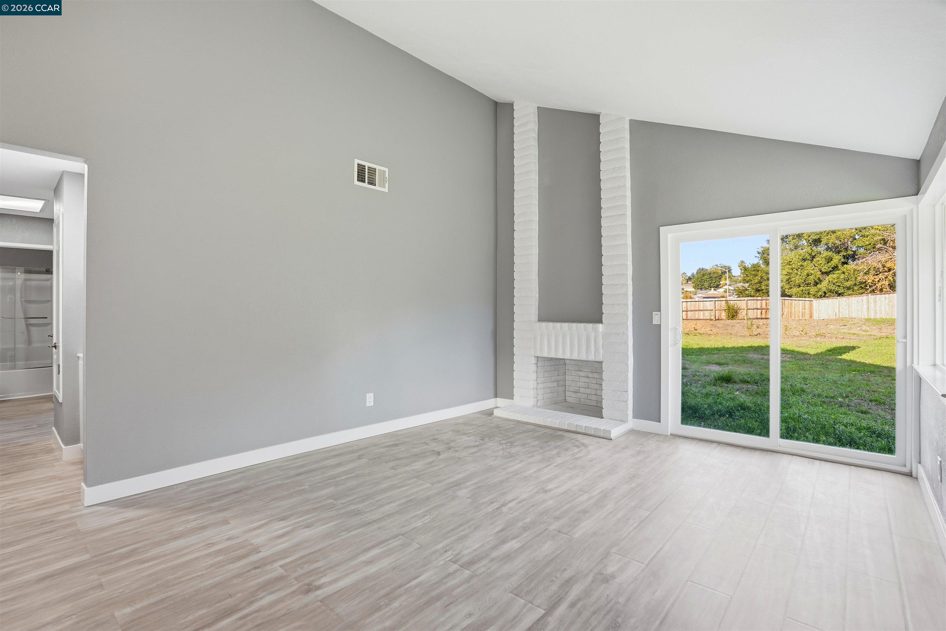 834 Coral Ridge Circle Rodeo, CA 94572 - Photo 5 of 32 a view of an empty room with wooden floor and a window
