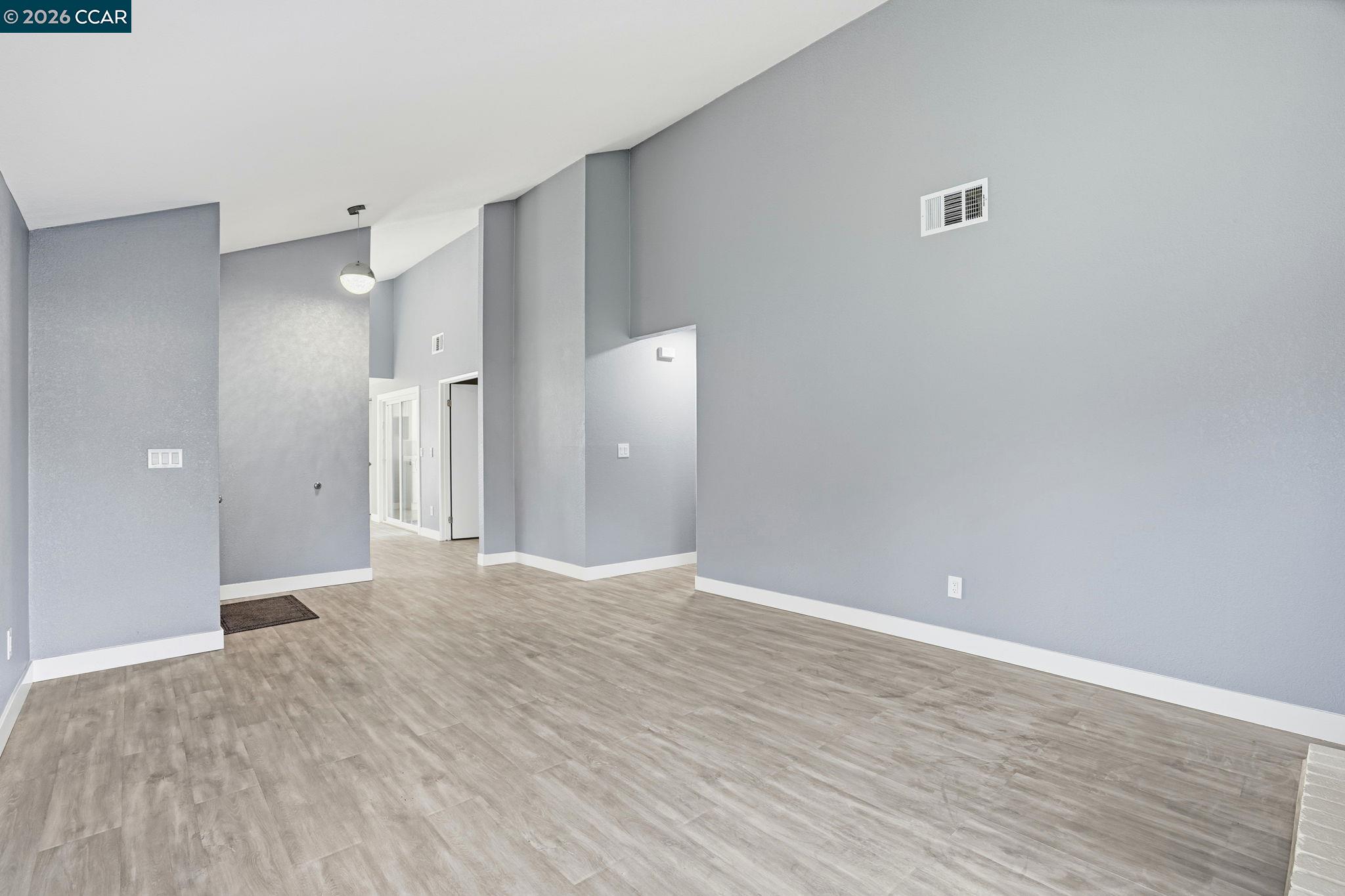 834 Coral Ridge Circle Rodeo, CA 94572 - Photo 6 of 32 a view of an empty room with wooden floor