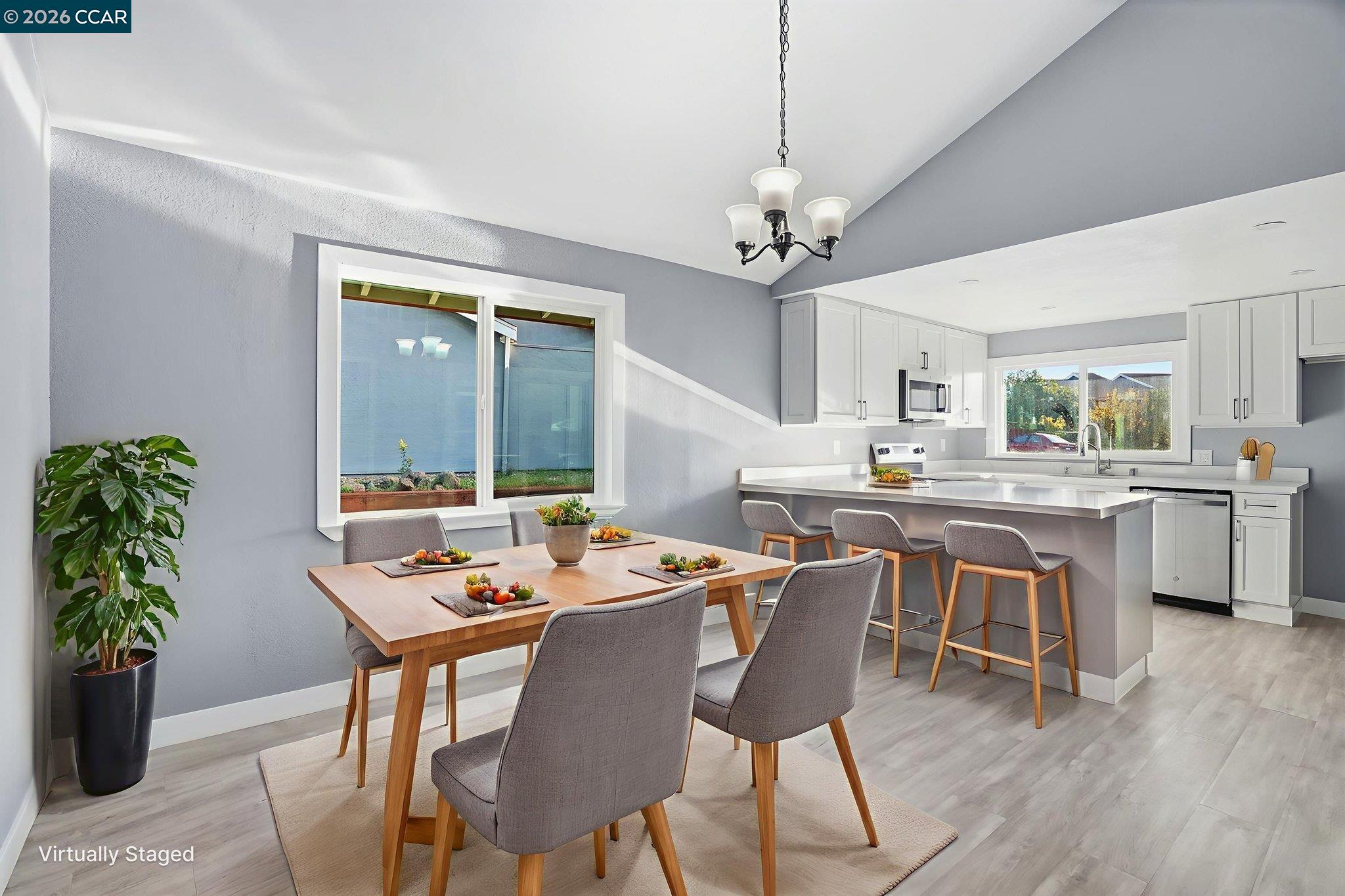 834 Coral Ridge Circle Rodeo, CA 94572 - Photo 10 of 32 a dining room with wooden floor a chandelier a wooden table and chairs