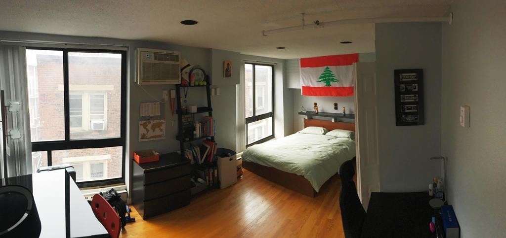 12 Stoneholm Street, Unit 520 Boston, MA 02115 - Photo 14 of 27 a bedroom with a bed and wooden floor