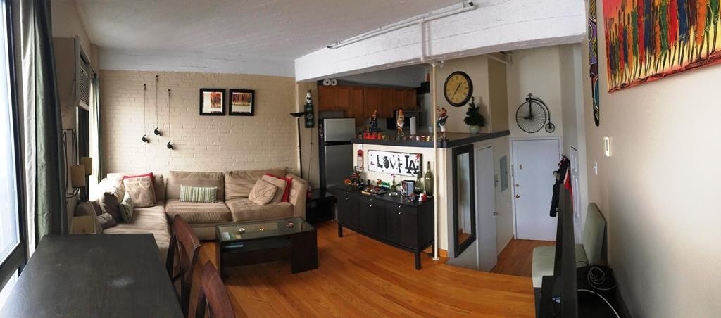 12 Stoneholm Street, Unit 520 Boston, MA 02115 - Photo 16 of 27 a living room with furniture and wooden floor