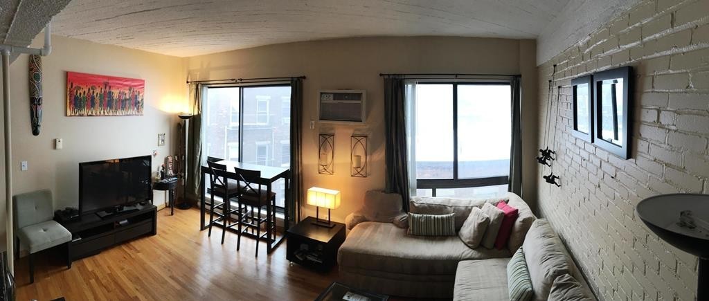 12 Stoneholm Street, Unit 520 Boston, MA 02115 - Photo 17 of 27 a living room with furniture and a flat screen tv