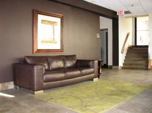 12 Stoneholm Street, Unit 520 Boston, MA 02115 - Photo 23 of 27 a living room with a couch and a fireplace