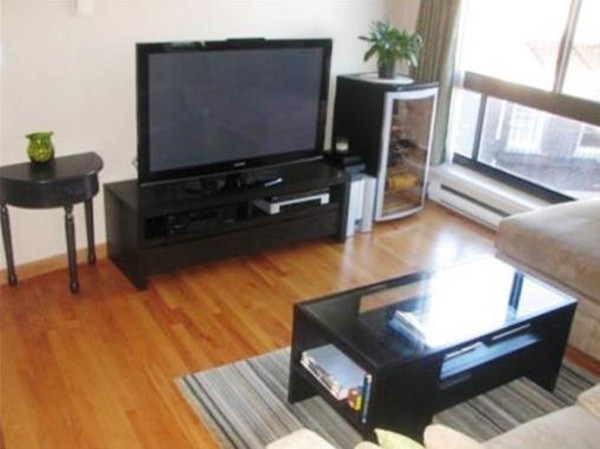 12 Stoneholm Street, Unit 520 Boston, MA 02115 - Photo 4 of 27 a living room with furniture and a flat screen tv