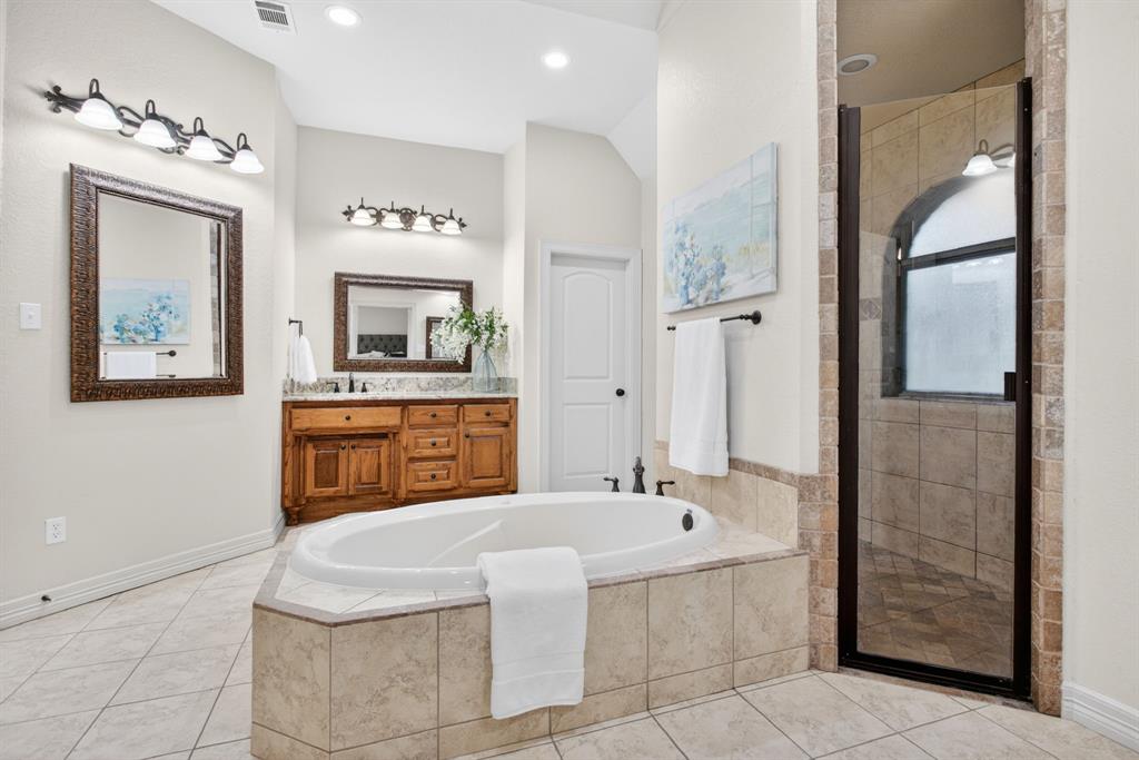 128 Canyon Ridge Trail Aledo, TX 76008 - Photo 24 of 40 Primary ensuite with separate vanities, big soaking tub, and a walkthrough shower.